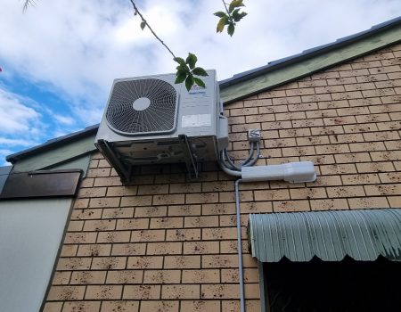air conditioner condensor unit installaed on a brick house in Springwood by Swind